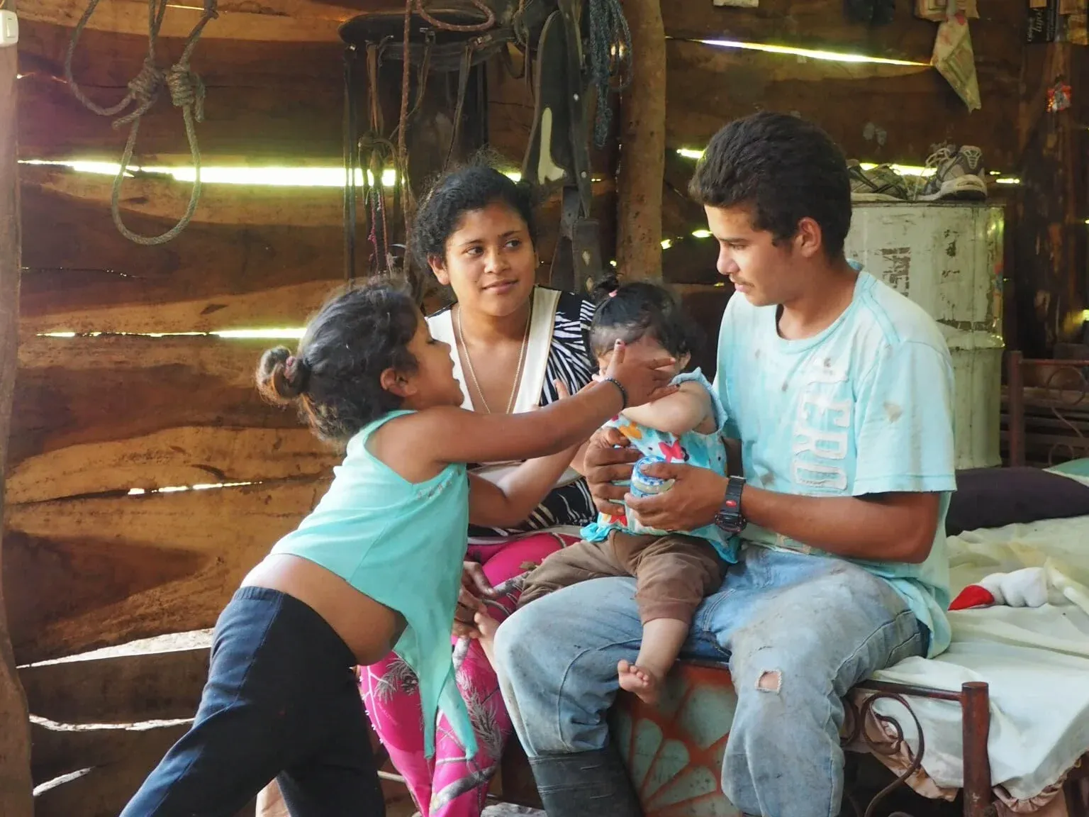 This is Alejandro (23) with his wife Maria (19), their infant daughter and Alejandro&#x27;s niece. They live in a section of Isiquí called El Carizo, which is only reachable via a steep, 30min hike from the center of the village. They have no r…